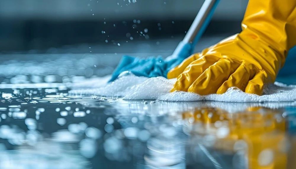 A gloved hand mopping a glossy floor
