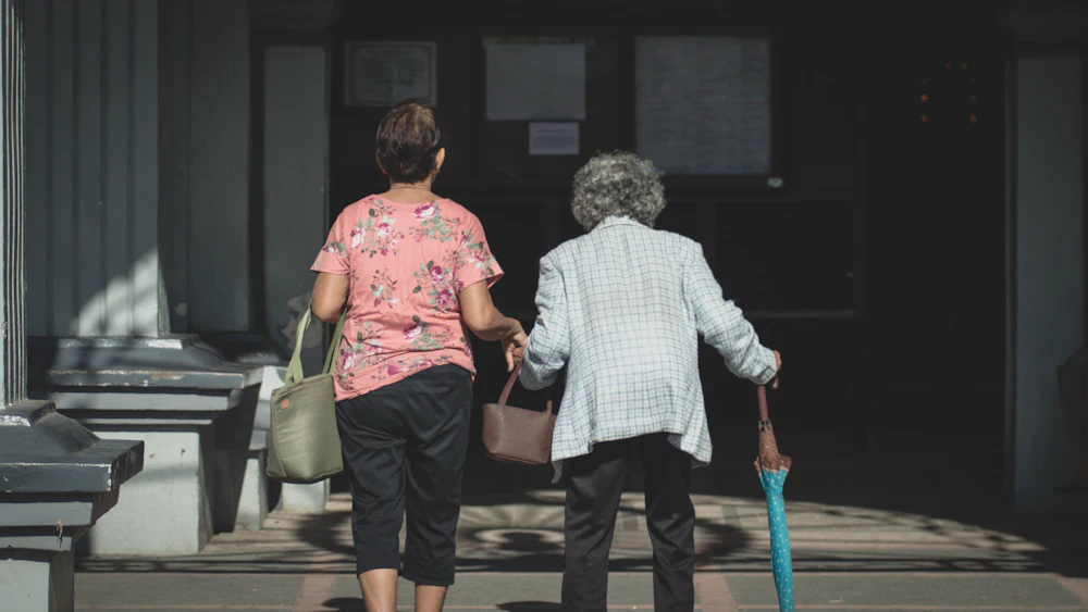Two people walking arm in arm