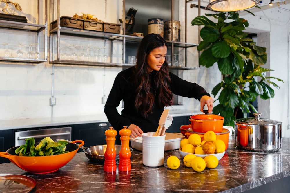 A cook preparing a meal in a bright home kitchen