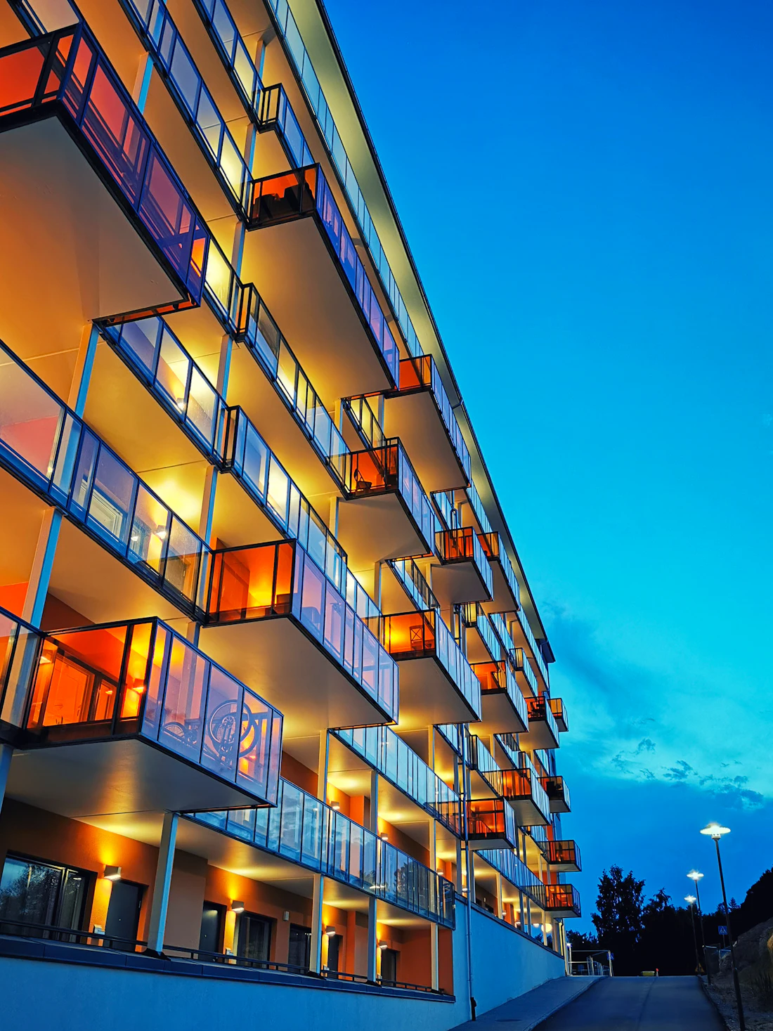 A residential apartment block glowing at dusk