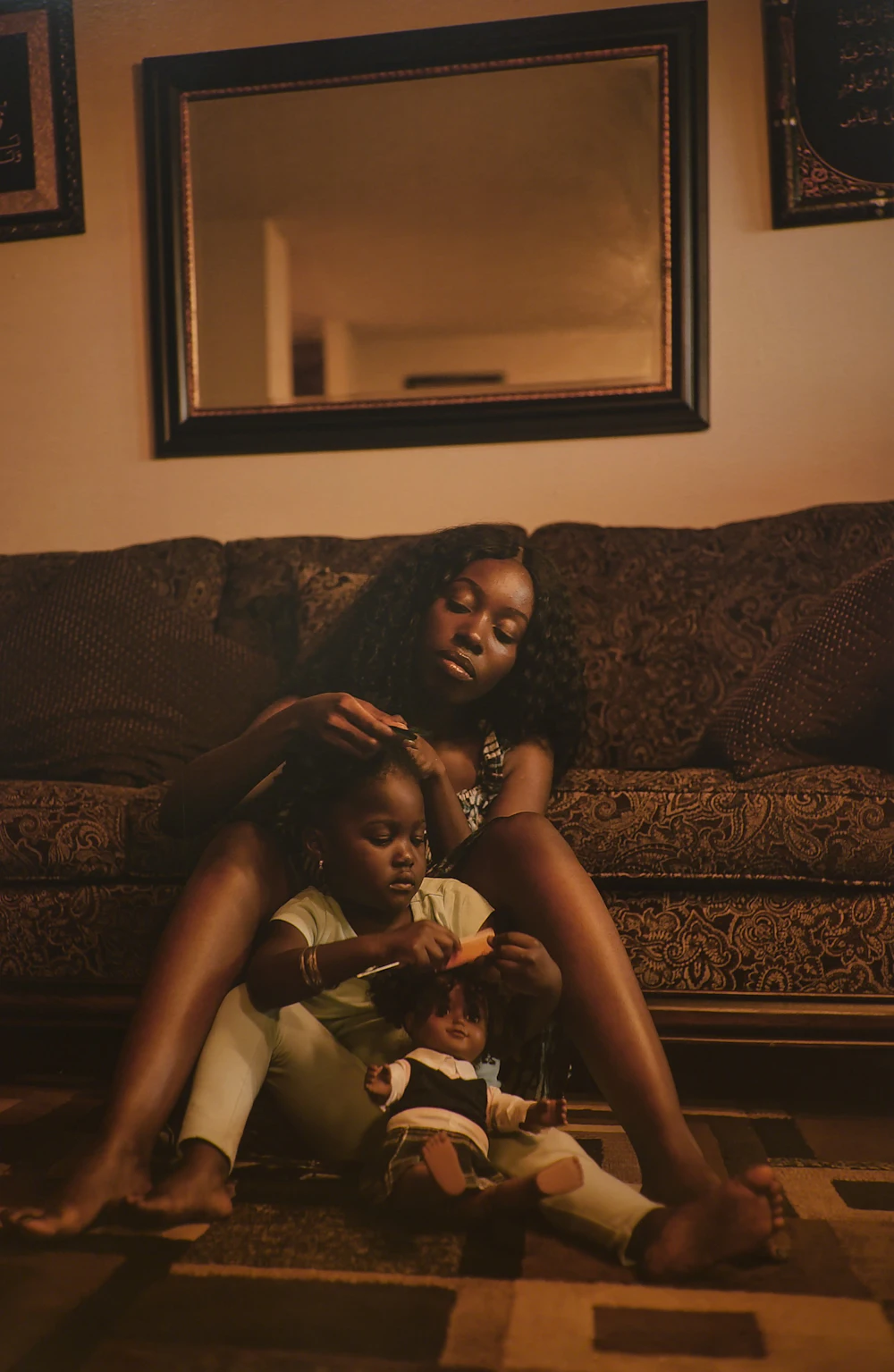 A mother gently styling her daughter's hair at home