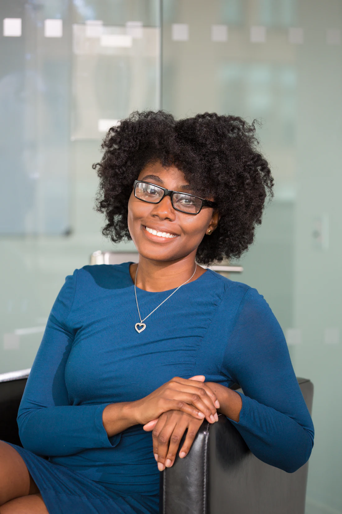 A smiling professional woman seated in a bright office